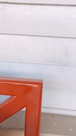 Close-up of detailed prefabricated wall panels with orange accents in a workshop