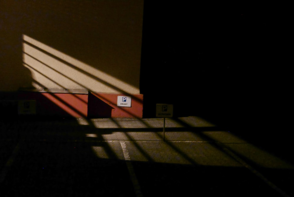 a shadow of a person standing on a tennis court