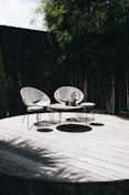 gray table with chair near trees