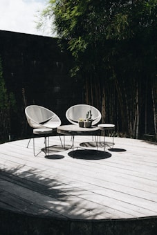 gray table with chair near trees