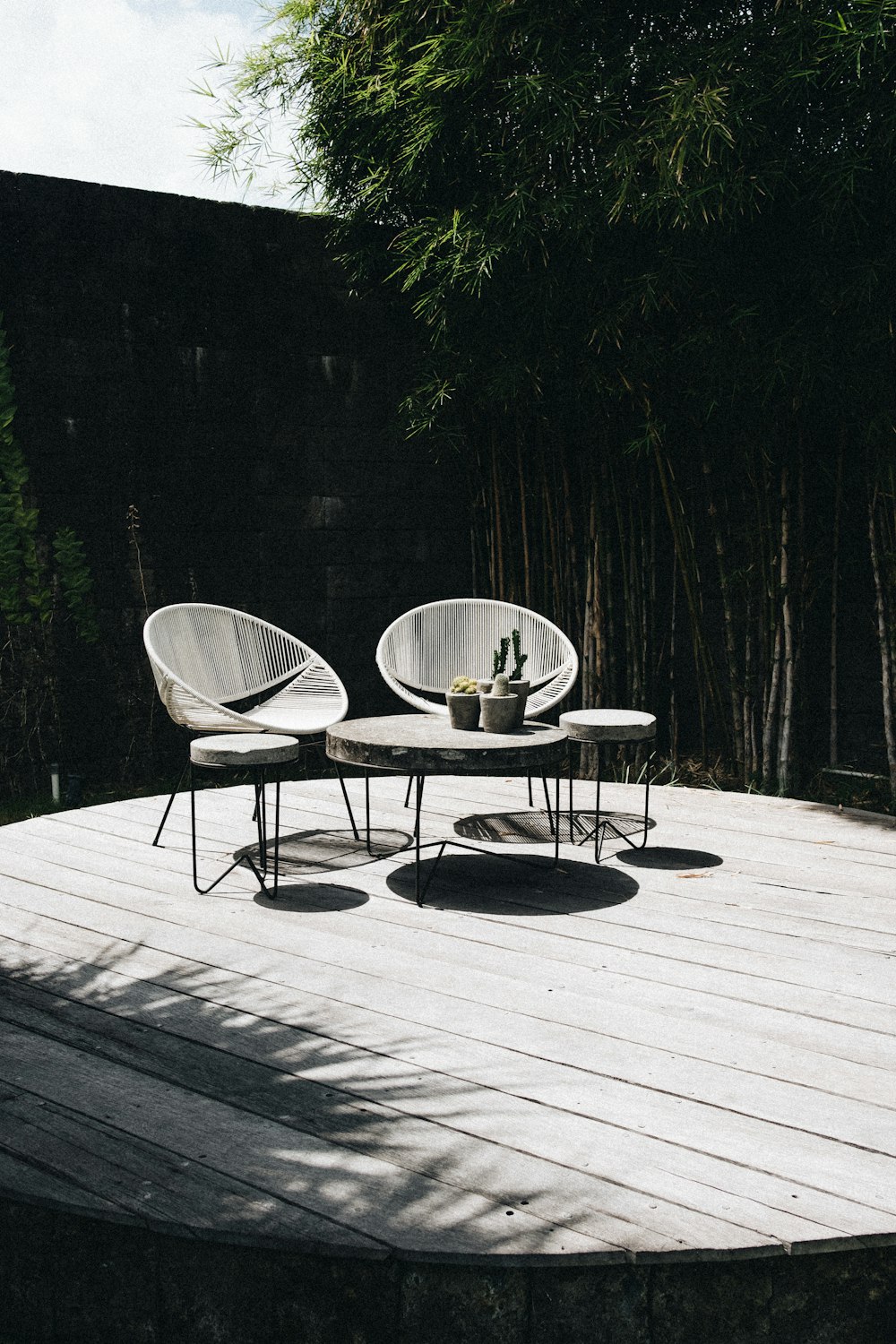 gray table with chair near trees