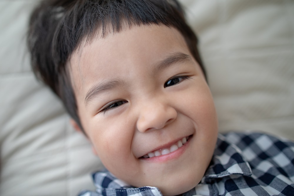 boy wearing white and black plaid sports shirt