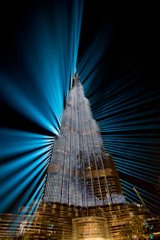Modern skyscraper under construction with animated light effects highlighting structural details.