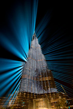 Modern skyscraper under construction with animated light effects highlighting structural details.