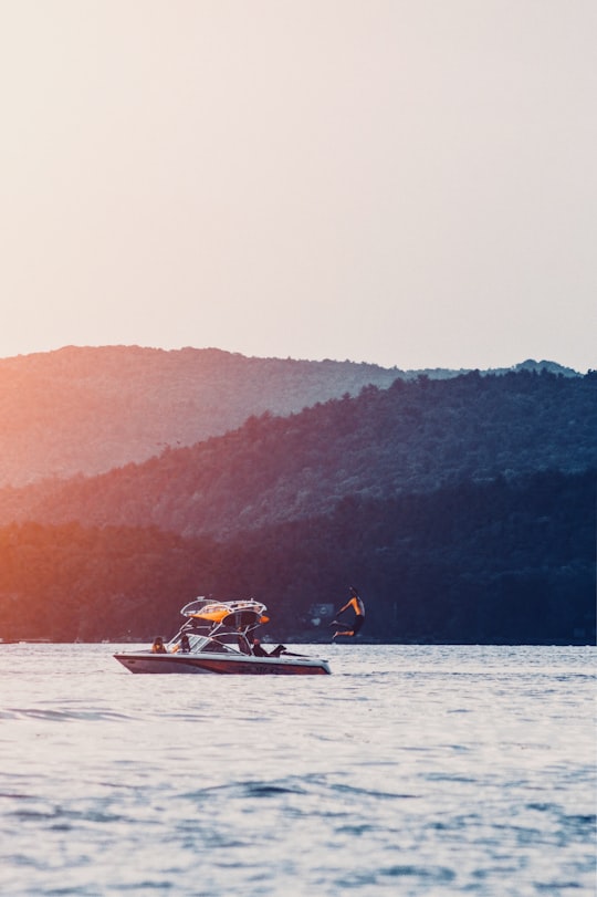 person jumping on water from boat in Vermont United States