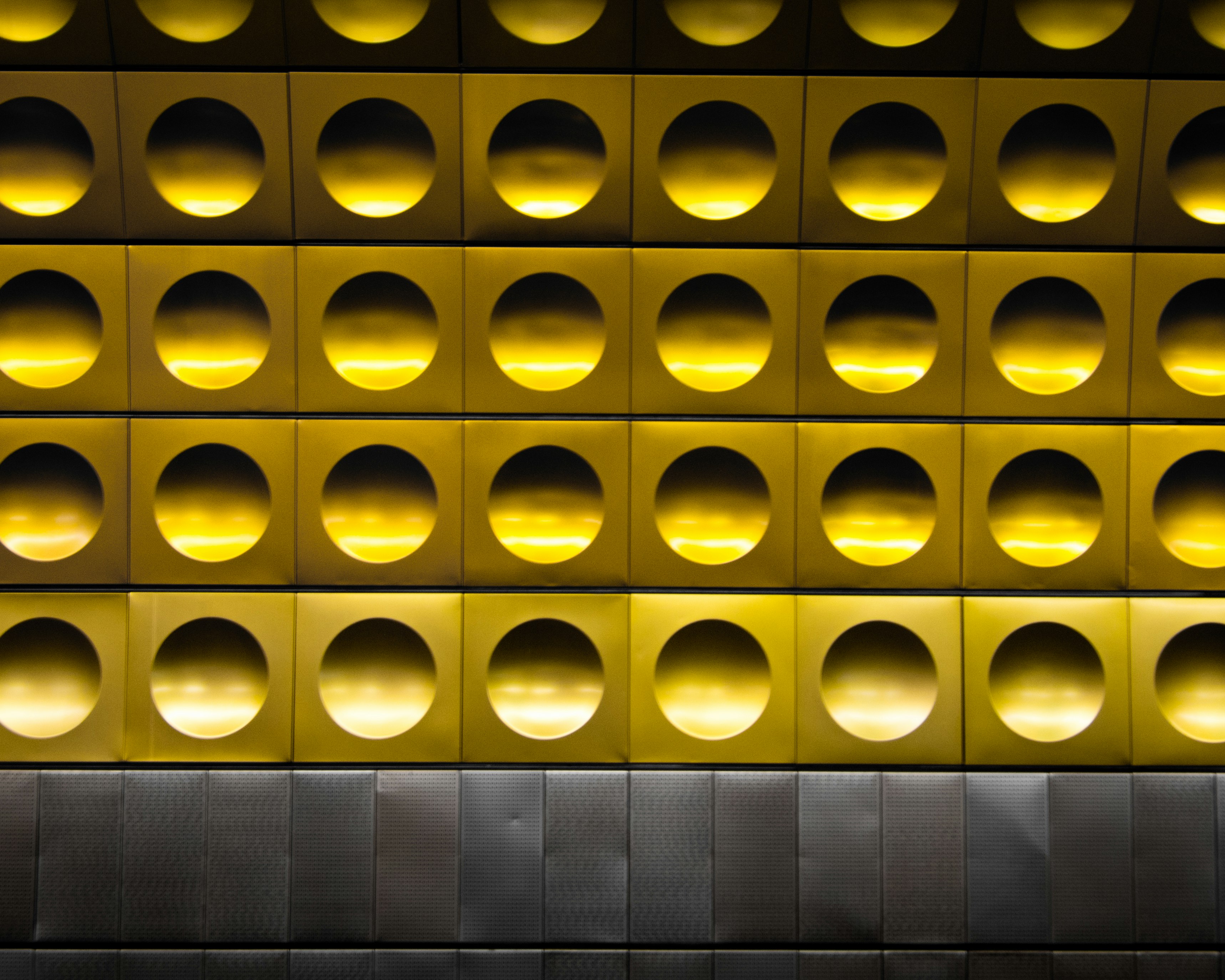 minimalist photography of gold and gray polka-dot wall