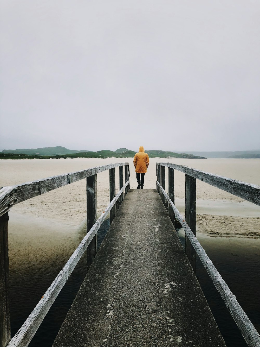 man stand on dock near body of water