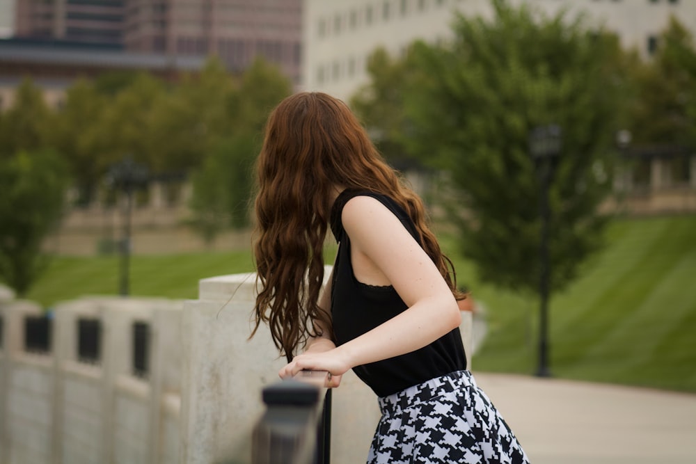 woman leaning on grills