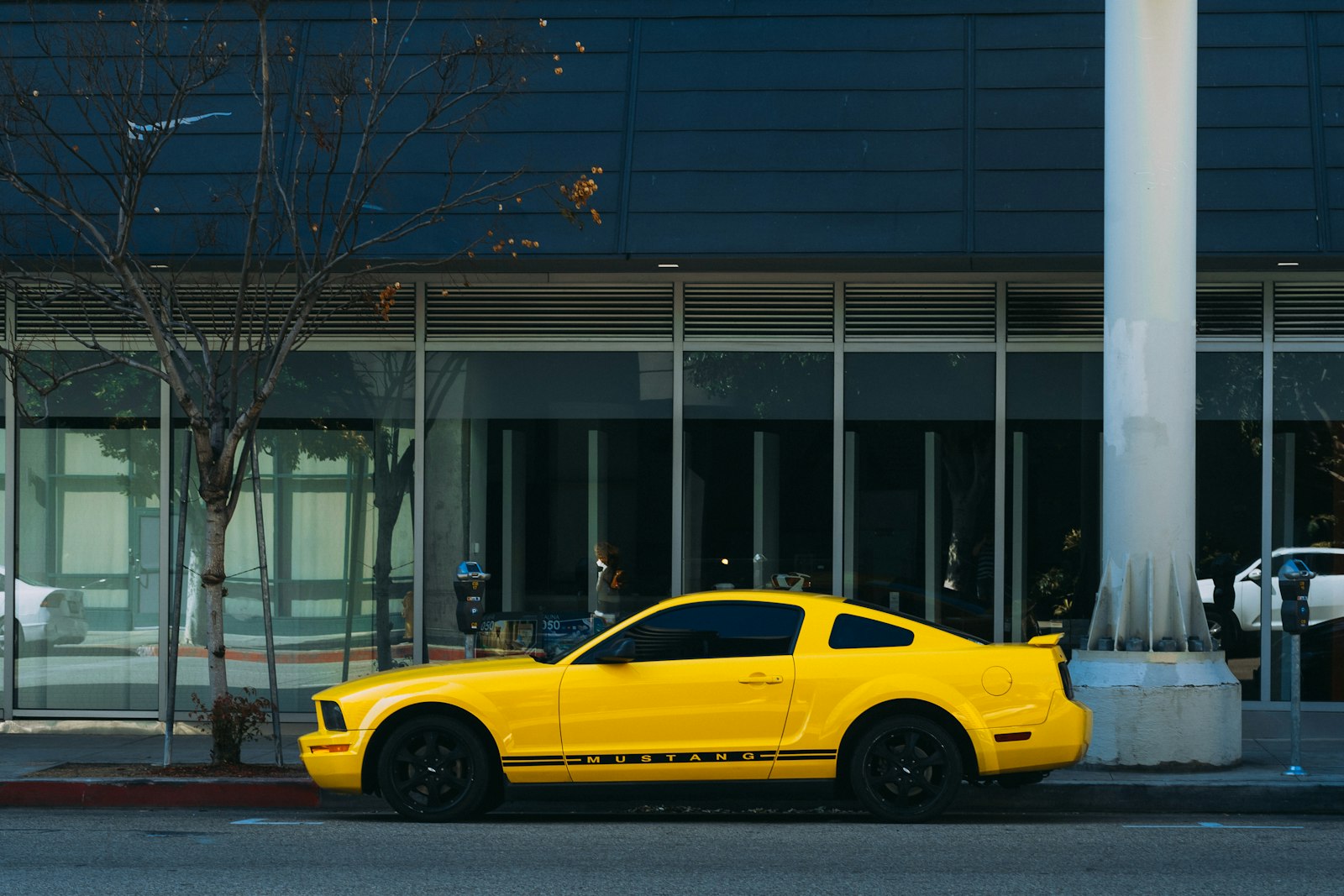 Sony FE 28-70mm F3.5-5.6 OSS sample photo. Yellow coupe parked outside photography