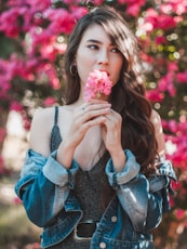 woman holding pink flower