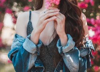 woman holding pink flower