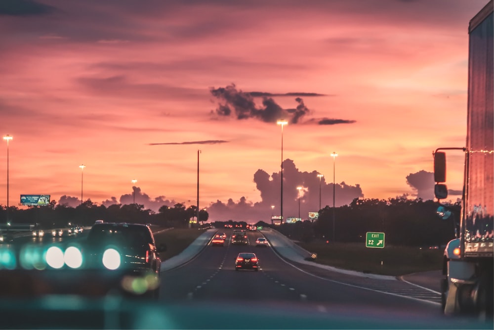 cars on road in sunset