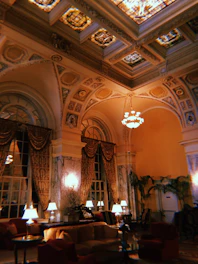 An opulent living room featuring plush furnishings, ambient lighting, and bespoke decor elements.