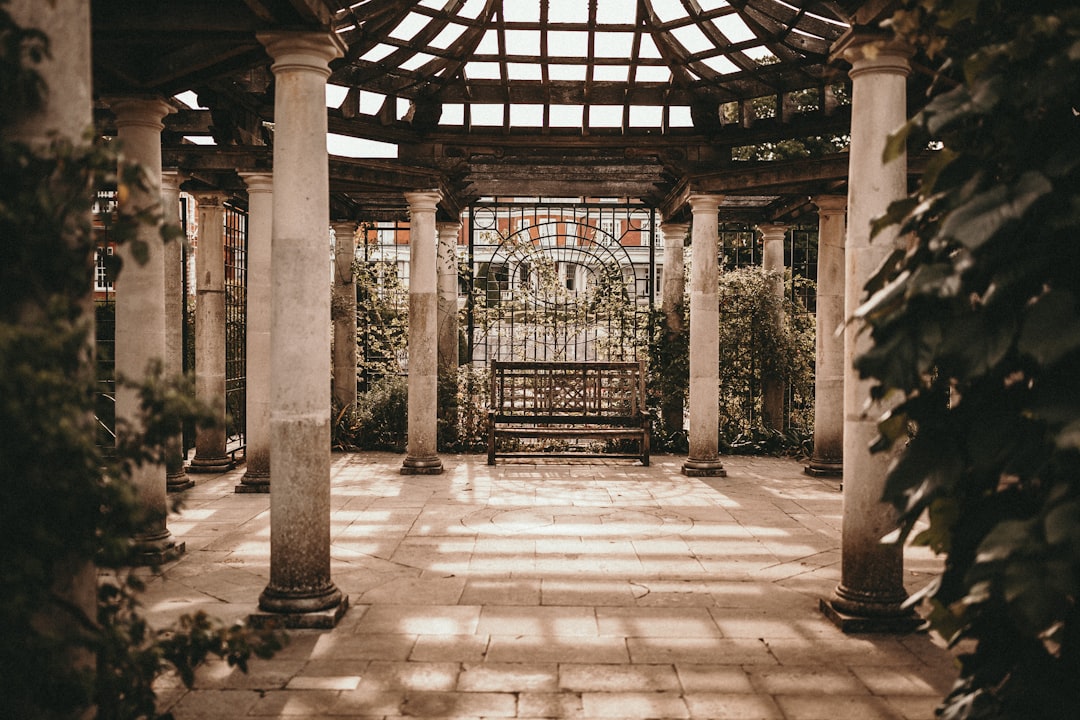 empty wooden bench between stone pillars, love