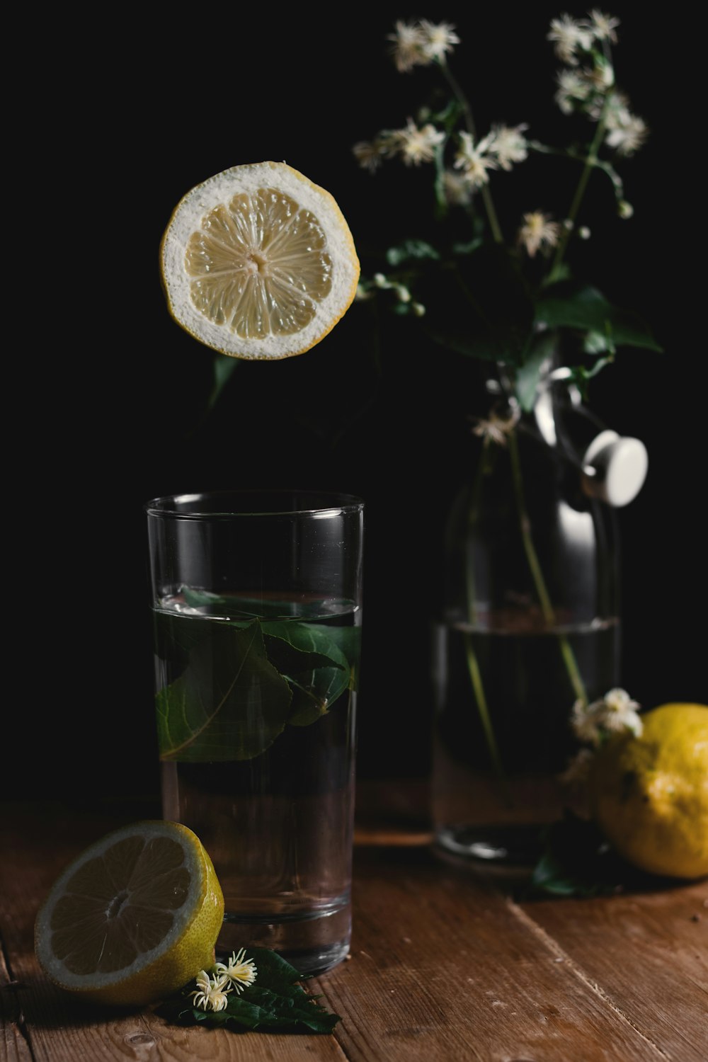 sliced lemon beside drinking glass
