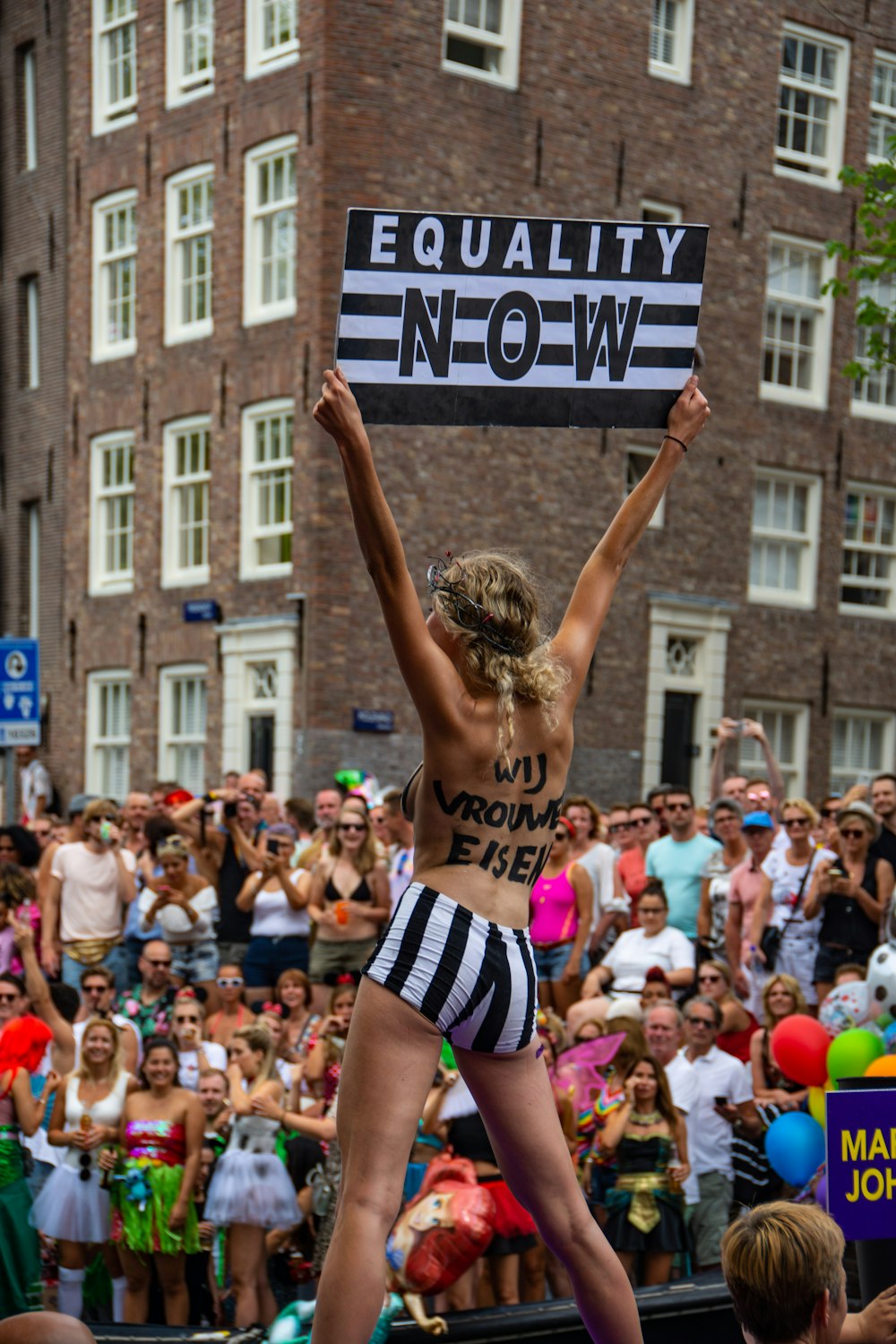 woman holding equality now banner