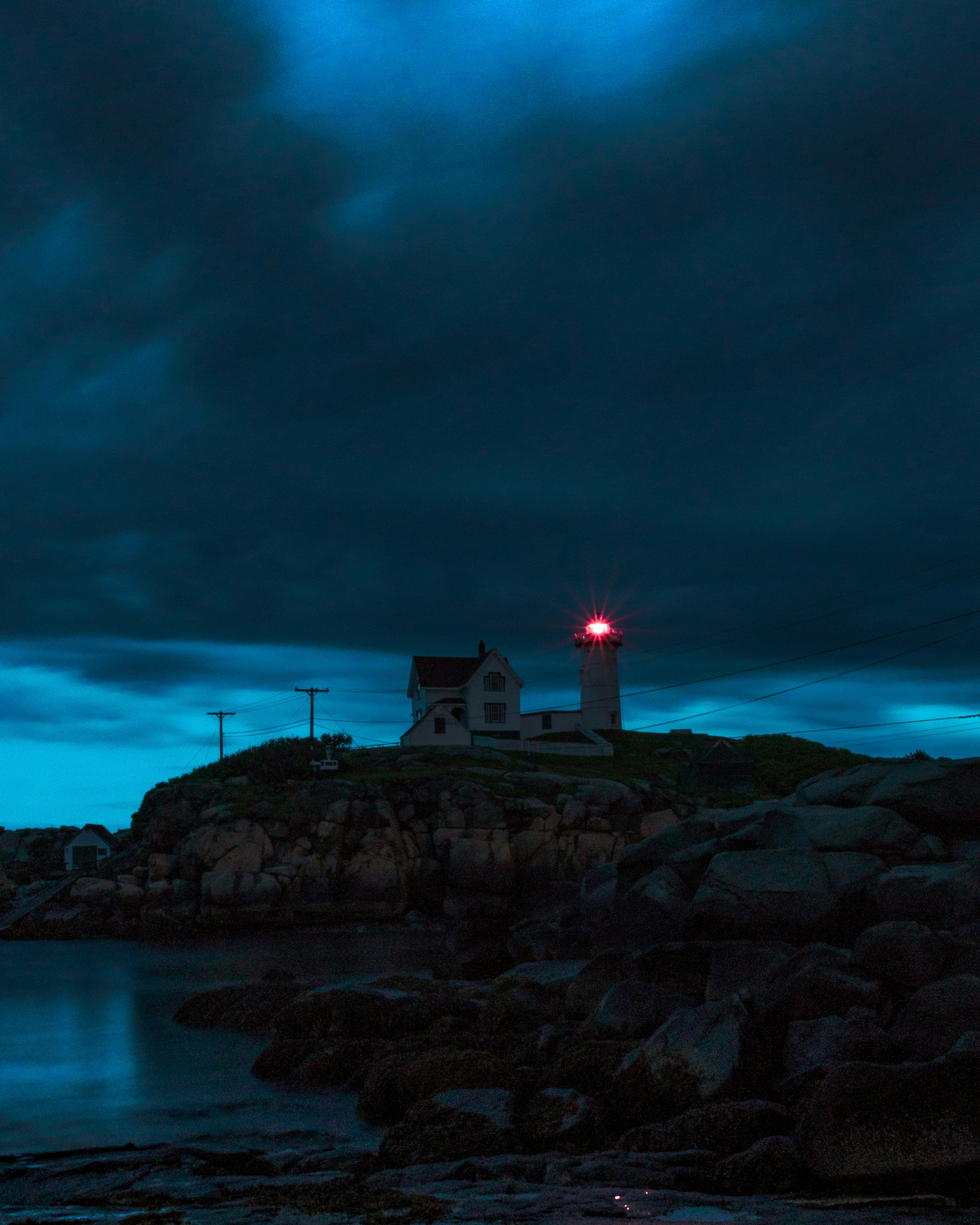 lighthouse beside body of water