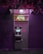 An ATM machine is located on a dark purple brick wall under a neon sign. The neon sign above the machine is colorful and reads 'ATM' in bright red, green, and blue lights. The area is dimly lit with purplish hues, creating a moody atmosphere.
