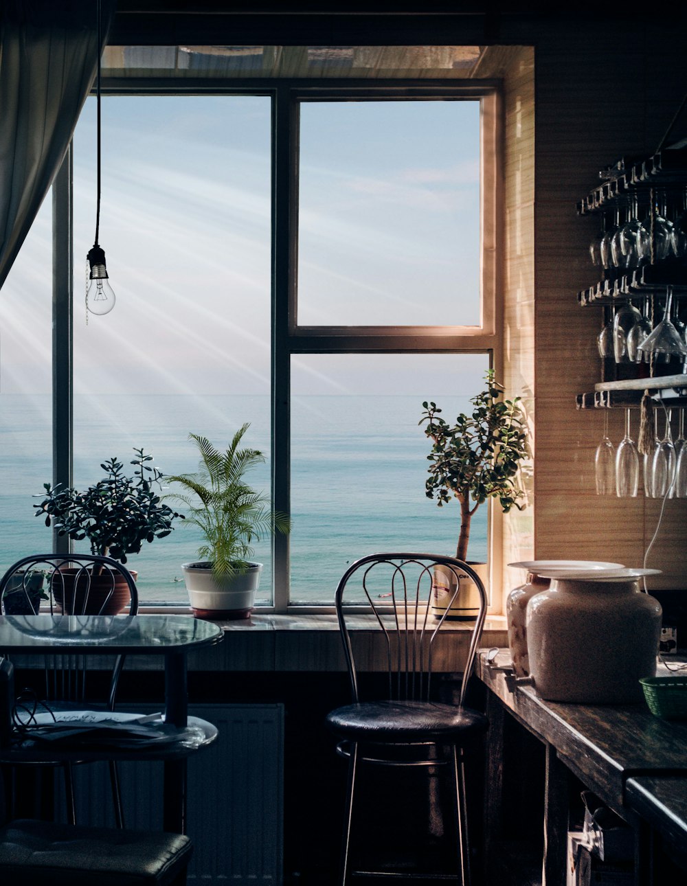 black bar stool near glass window