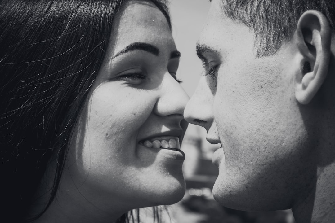 woman and man facing each other while smiling