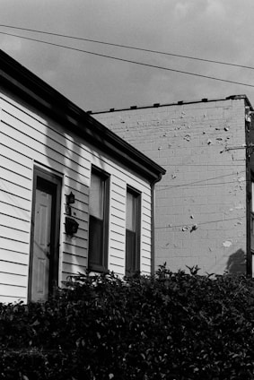 A professional inspector examining a residential property exterior.