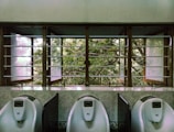 three male urinal in room