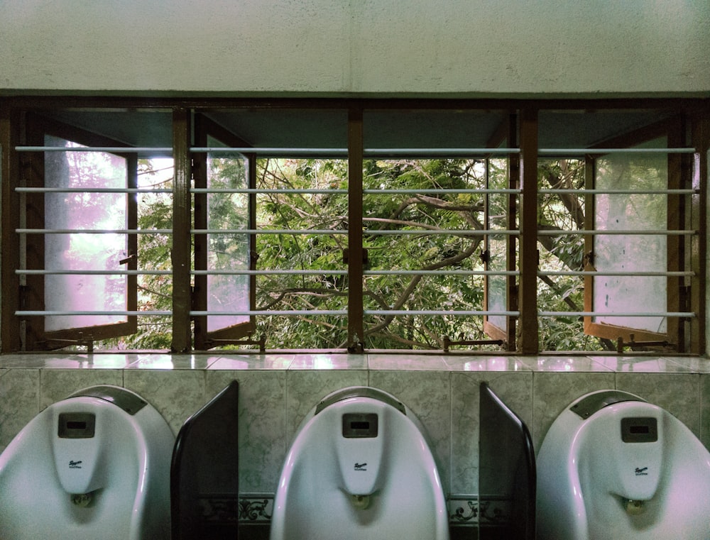 three male urinal in room