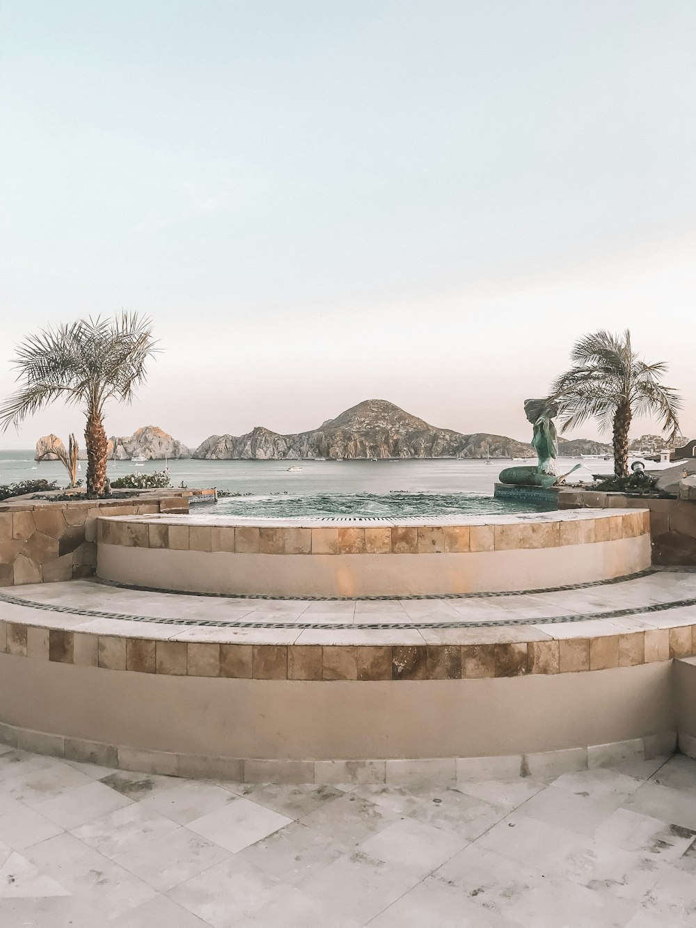 two palm trees in between pool