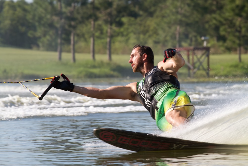man riding wakeboard doing tricks