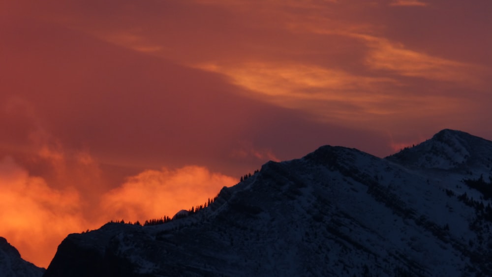 snow capped mountain under golden hour