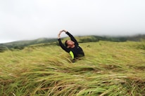 A person enjoying a peaceful morning stretch outdoors, embracing wellness.
