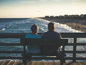 A caregiver walking alongside a senior resident outdoors