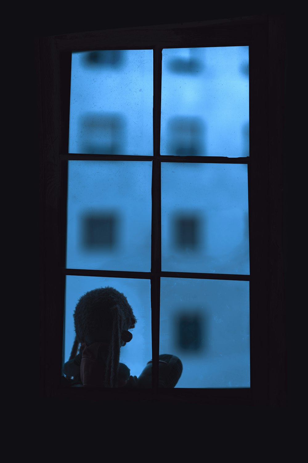 silhouette of person standing near window