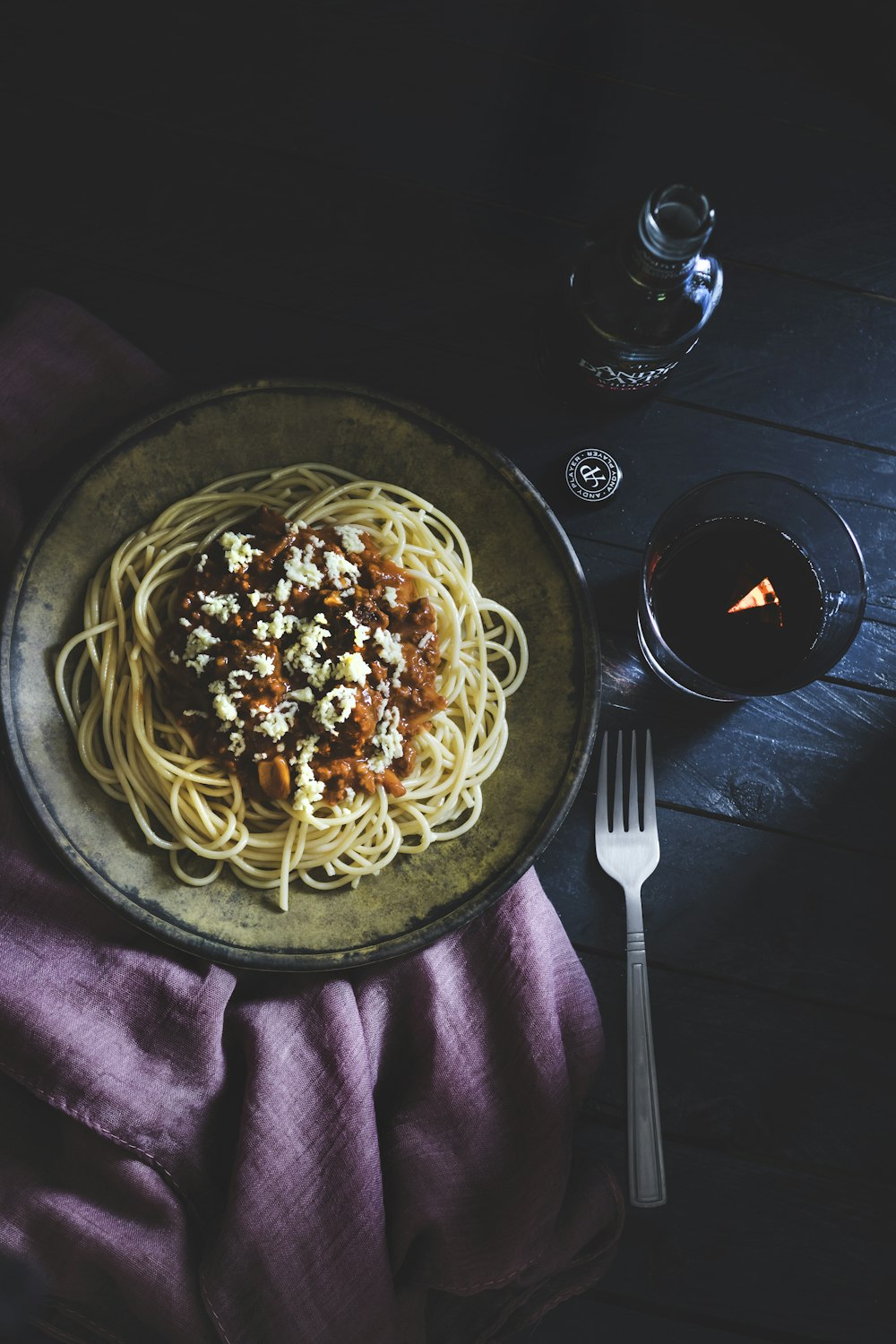 cooked pasta dish on round brown ceramic plate