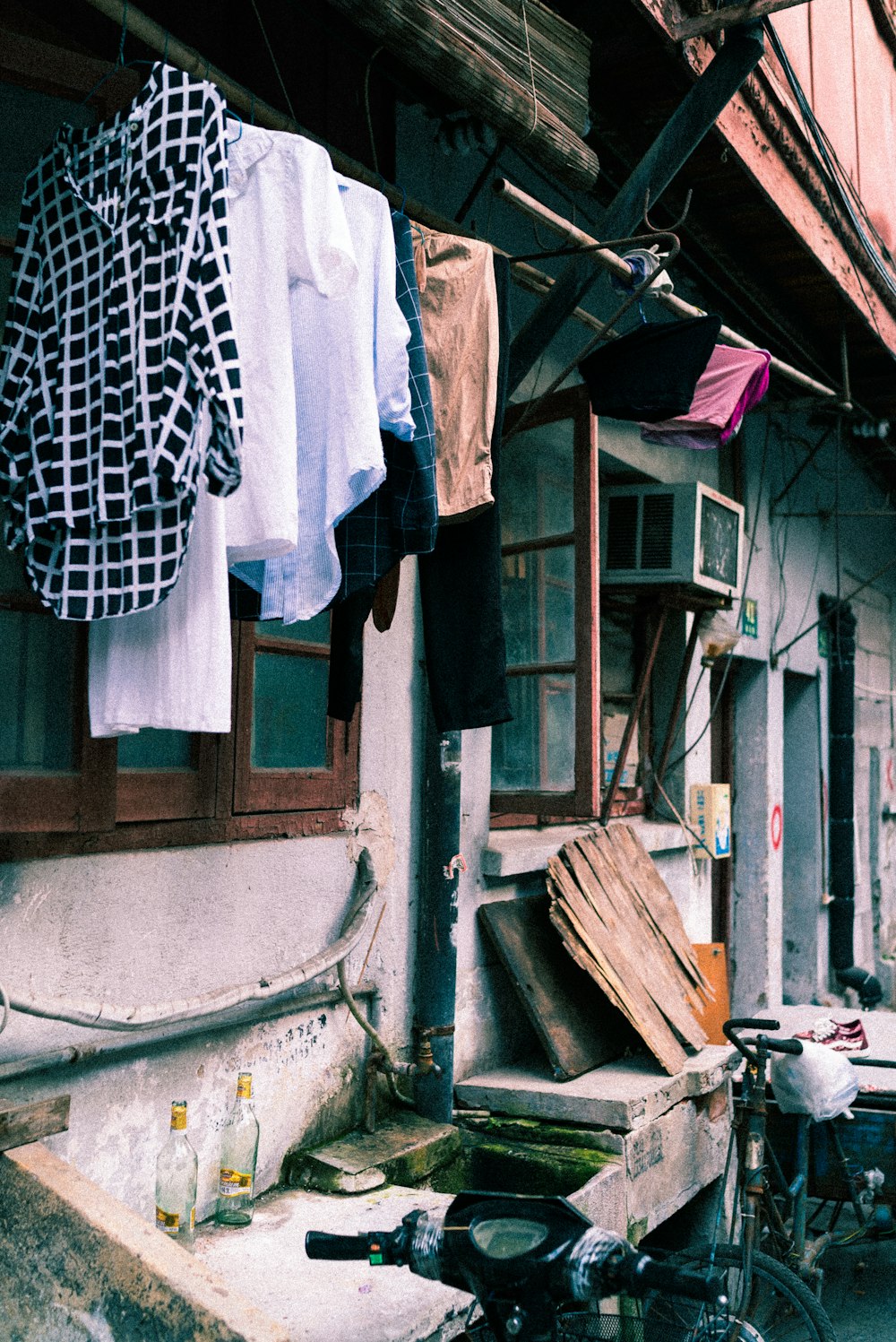 assorted clothes hanged on clothesline outside window