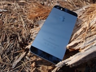 Google Pixel phone resting on a wooden table with natural light emphasizing its design.