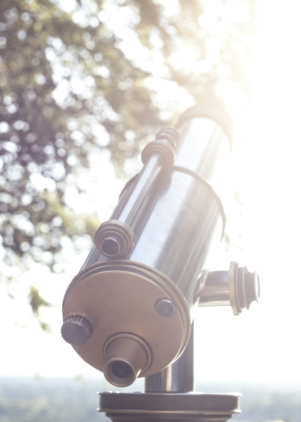 black and silver telescope on top of silver stand