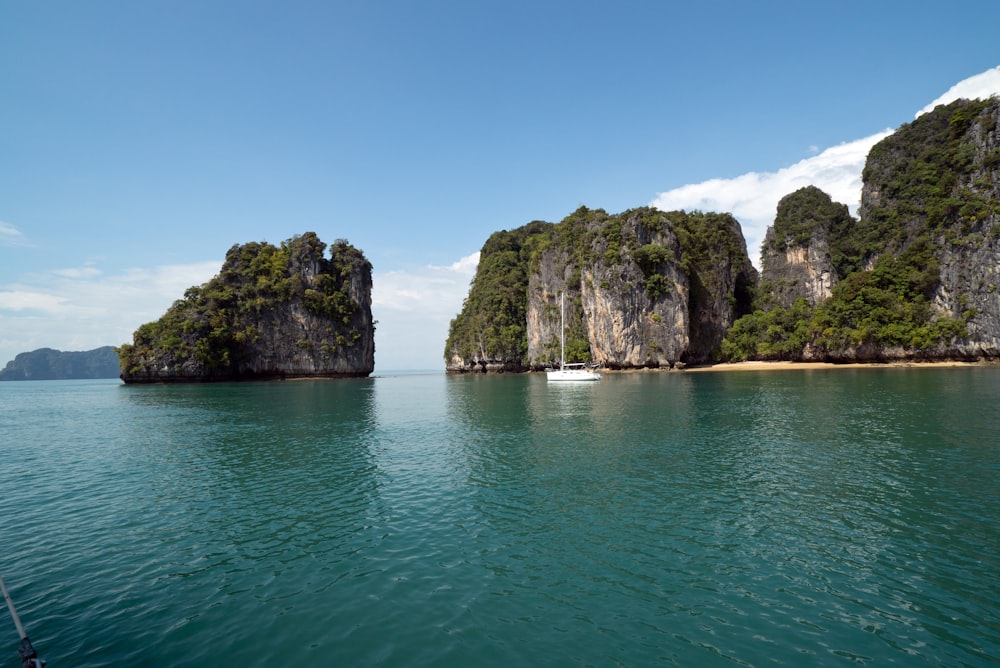 rock formation surrounded by body of water