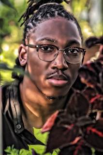 A vibrant outdoor portrait session with natural greenery in the background.