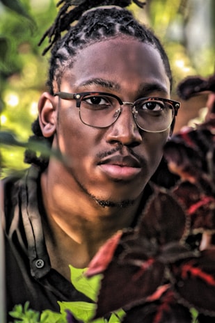 A vibrant outdoor portrait session with natural greenery in the background.