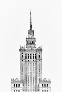 grayscale photo of Gothic concrete tower clock