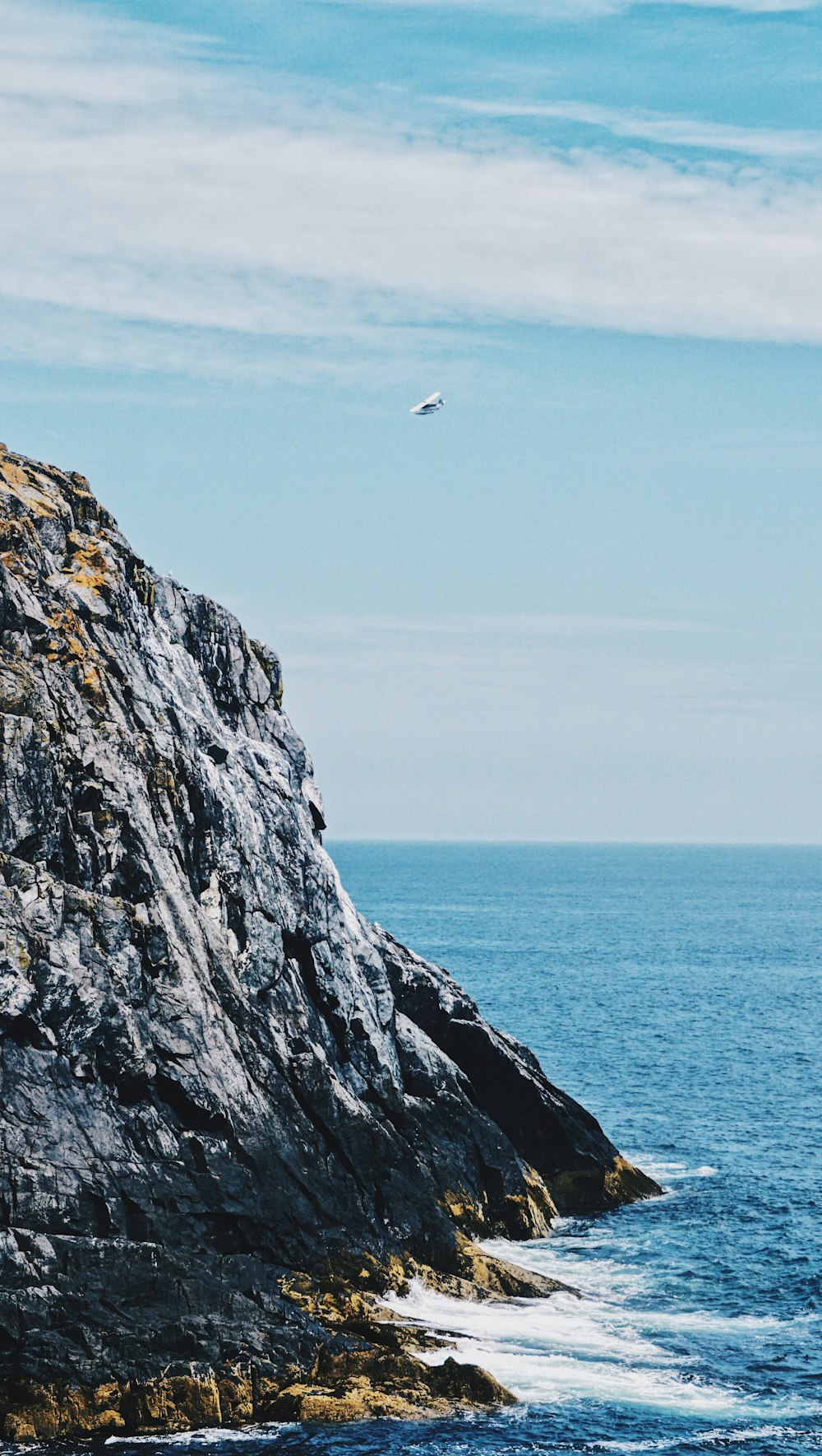 rock formation surrounded of body of water