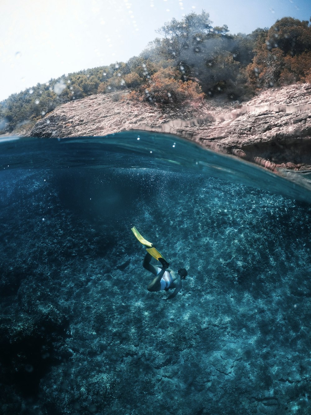 person diving on body of water