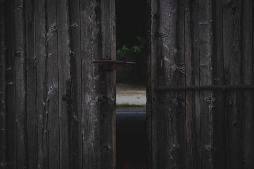 half opened brown wooden gate