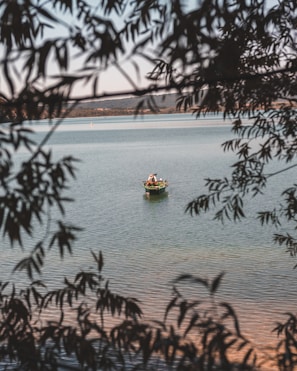 A small group enjoying a peaceful fishing trip by a calm Podlasie lake at sunrise