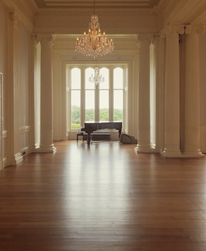 A calm, elegant room decorated with pastel pink and purple tones, set up for a peaceful music therapy session.