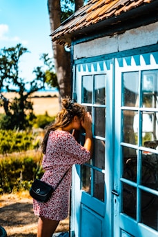woman peeking on glass door