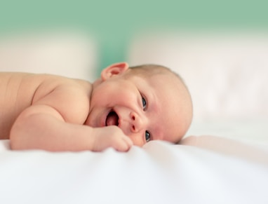 baby lying on a blanket