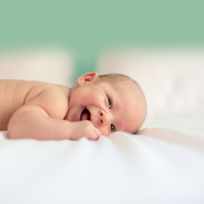 baby lying on a blanket