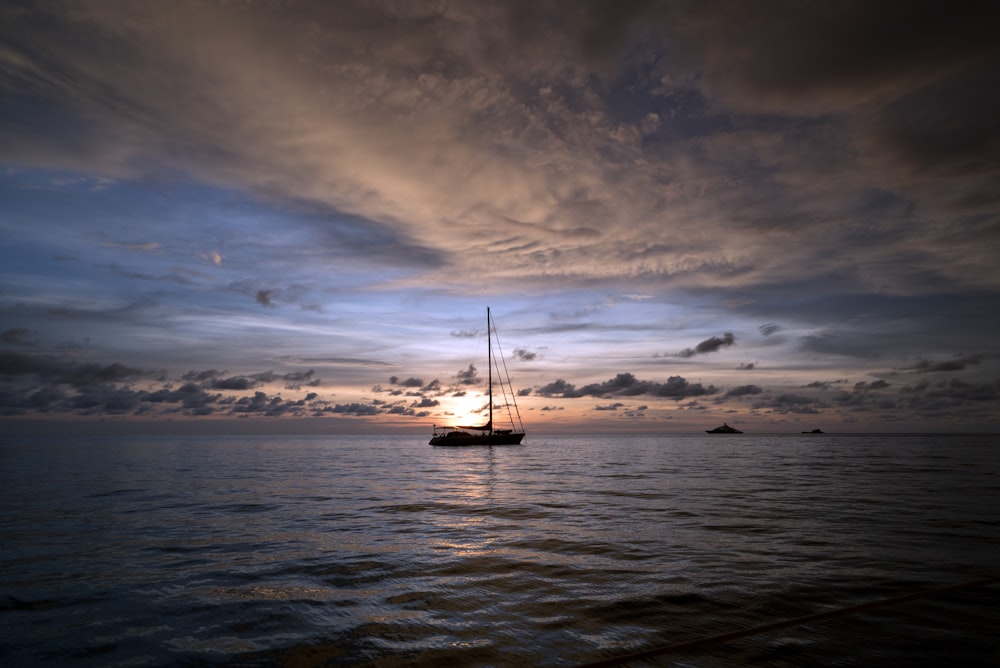 silhouette of boat floating on body of water